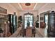 Elegant dining room featuring a tray ceiling, classic furniture, and large windows at 1300 Sw 43Rd Pl, Ocala, FL 34471