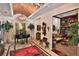Inviting foyer featuring elegant decor, a grand piano, and a view into the adjacent library at 1300 Sw 43Rd Pl, Ocala, FL 34471