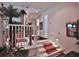 Welcoming foyer with staircase, potted plants, and decorative touches at 1300 Sw 43Rd Pl, Ocala, FL 34471