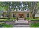 Charming brick home featuring a symmetrical design, manicured landscaping, and a welcoming brick pathway to the entrance at 1300 Sw 43Rd Pl, Ocala, FL 34471