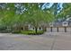 Spacious home with a large driveway, multiple garage doors, and manicured landscaping at 1300 Sw 43Rd Pl, Ocala, FL 34471