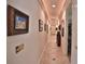 Hallway featuring travertine floors and a collection of framed pictures on the walls, enhanced by recessed lighting at 1300 Sw 43Rd Pl, Ocala, FL 34471