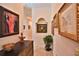 Hallway featuring neutral walls, travertine floors, elegant trim, and sophisticated decorations at 1300 Sw 43Rd Pl, Ocala, FL 34471