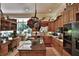 Spacious kitchen with an island, decorative features, stainless steel appliances, and a view to the backyard at 1300 Sw 43Rd Pl, Ocala, FL 34471