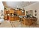 Split level kitchen with granite countertops, wooden cabinets and bar stool seating at 1300 Sw 43Rd Pl, Ocala, FL 34471