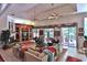 Large living room featuring built-in entertainment center, ceiling fans and bright natural light at 1300 Sw 43Rd Pl, Ocala, FL 34471
