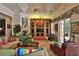 Comfortable living room with fireplace, built-in shelving and natural light from large windows at 1300 Sw 43Rd Pl, Ocala, FL 34471