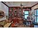 Spacious office with custom built-in bookshelves, comfortable seating, and a bright window at 1300 Sw 43Rd Pl, Ocala, FL 34471