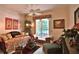Charming sitting area featuring a wicker daybed, chaise lounge, and an abundance of natural light from a large window at 1300 Sw 43Rd Pl, Ocala, FL 34471