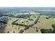 Stunning aerial view of sprawling acreage featuring multiple homesites, mature trees, and pristine landscaping at 0000 Se 116Th Place Rd, Ocala, FL 34480