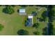 Overhead aerial shot displaying a home with accessory building, framed by verdant trees and lawns at 1058 Se 59Th St, Ocala, FL 34480