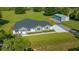 Stunning aerial view of a home with a beautiful lot, accessory building, and pristine landscaping at 1058 Se 59Th St, Ocala, FL 34480