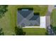 Aerial view of the home's roof, driveway, landscaping, and surrounding lawn at 1058 Se 59Th St, Ocala, FL 34480