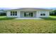 A wide backyard view of the home's exterior and patio, emphasizing outdoor living space at 1058 Se 59Th St, Ocala, FL 34480