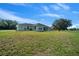 Expansive backyard with lush green grass and a clear view of the home's exterior at 1058 Se 59Th St, Ocala, FL 34480
