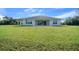 A lush green backyard view, highlighting the home's exterior and outdoor space at 1058 Se 59Th St, Ocala, FL 34480