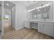 Elegant bathroom featuring a double vanity, modern fixtures, and wood-look floors at 1058 Se 59Th St, Ocala, FL 34480