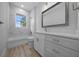Bathroom featuring marble accents, a window, and a modern vanity at 1058 Se 59Th St, Ocala, FL 34480
