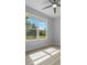 Sunlit bedroom with a large window and a view of the green outdoors at 1058 Se 59Th St, Ocala, FL 34480