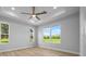 Bright bedroom features a ceiling fan and natural light from the windows at 1058 Se 59Th St, Ocala, FL 34480