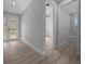 Neutral bedroom leading to the bathroom, featuring an exterior door to the backyard at 1058 Se 59Th St, Ocala, FL 34480