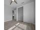 Neutral bedroom featuring a closet with sliding doors and durable wood-look flooring at 1058 Se 59Th St, Ocala, FL 34480