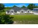 Attractive single-Gathering home featuring manicured lawn, stone accents, and an adjacent storage building at 1058 Se 59Th St, Ocala, FL 34480