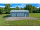 Exterior view of new metal building with two garage doors on a grassy lot at 1058 Se 59Th St, Ocala, FL 34480