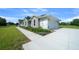 The home's charming exterior features a well-maintained lawn, stone accents, and a convenient two-car garage at 1058 Se 59Th St, Ocala, FL 34480