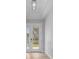 Bright foyer with a view of the front yard through the glass front door at 1058 Se 59Th St, Ocala, FL 34480