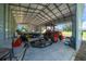 Spacious garage featuring a boat, trailer, tractor, and other equipment at 1058 Se 59Th St, Ocala, FL 34480