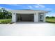 Attached garage with bright lighting, white paint, and a pristine concrete floor at 1058 Se 59Th St, Ocala, FL 34480