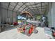 A well-organized garage containing various lawn and watercraft equipment, including a lawnmower and a boat at 1058 Se 59Th St, Ocala, FL 34480