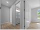 Hallway leading to a bathroom with tile floor and neutral paint at 1058 Se 59Th St, Ocala, FL 34480