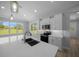 Modern kitchen features an island with sink, modern cabinets, and stainless steel appliances at 1058 Se 59Th St, Ocala, FL 34480
