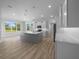 Bright open kitchen features a large island, stainless appliances, and hardwood floors at 1058 Se 59Th St, Ocala, FL 34480