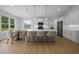 Kitchen with white cabinets, stainless appliances, a large island with chairs, and a dining table at 1058 Se 59Th St, Ocala, FL 34480
