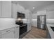 Kitchen featuring stainless steel appliances, white cabinets, and quartz countertops at 1058 Se 59Th St, Ocala, FL 34480