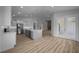 Open kitchen with island, stainless steel appliances, and light wood floors at 1058 Se 59Th St, Ocala, FL 34480