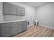 Laundry room featuring custom cabinets and a utility sink at 1058 Se 59Th St, Ocala, FL 34480