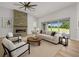 Cozy living room with modern fireplace, ample seating, and large windows overlooking the backyard at 1058 Se 59Th St, Ocala, FL 34480