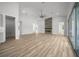 Open-concept living room with wood-look floors and a view of the fireplace at 1058 Se 59Th St, Ocala, FL 34480
