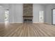 Spacious living room with a striking stone fireplace, recessed lighting, and sleek, modern flooring at 1058 Se 59Th St, Ocala, FL 34480