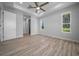 Spacious bedroom featuring wood-look flooring, tray ceilings, and natural light from picturesque windows at 1058 Se 59Th St, Ocala, FL 34480