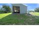 Exterior view of a metal outbuilding with an open bay door at 1058 Se 59Th St, Ocala, FL 34480