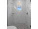 White tiled shower with pebbled floor and window at 1058 Se 59Th St, Ocala, FL 34480