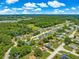 A bird's eye view of a home nestled in a verdant neighborhood, showcasing its serene setting at 10739 Se 44Th Ter, Belleview, FL 34420