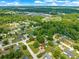This aerial shot highlights a home in a peaceful, tree-lined neighborhood, offering a sense of community at 10739 Se 44Th Ter, Belleview, FL 34420