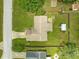 Aerial view of a well-maintained home featuring a spacious, grassy backyard and mature trees at 10739 Se 44Th Ter, Belleview, FL 34420