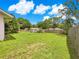 Expansive backyard with mature tree coverage, green lawn, and storage shed at 10739 Se 44Th Ter, Belleview, FL 34420